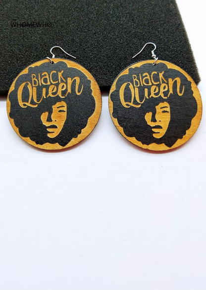 Wooden earrings with a graphic of a woman with an Afro and the words Black Queen emblazoned across the top. 