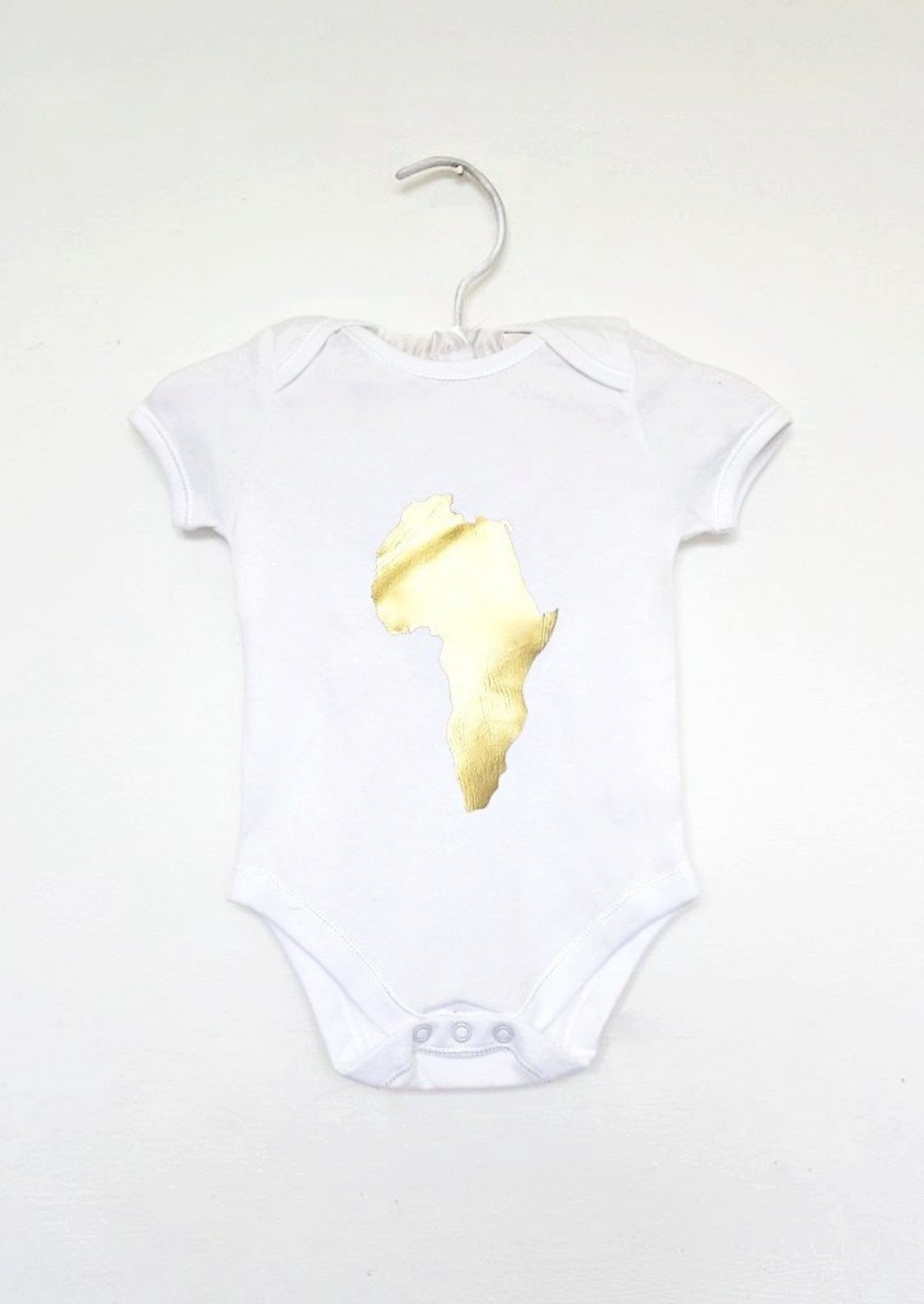 Baby bodysuit: This baby romper is a white short sleeve playsuit with gold map of Africa on the centre of the chest.